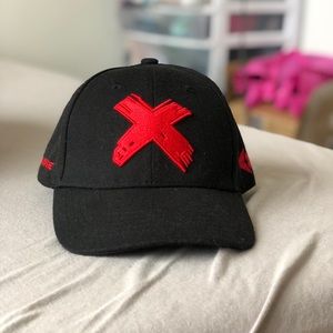 Edgy black snap back cap with red X